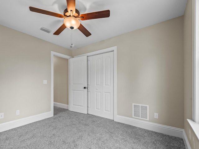 unfurnished bedroom featuring carpet floors, a closet, and ceiling fan