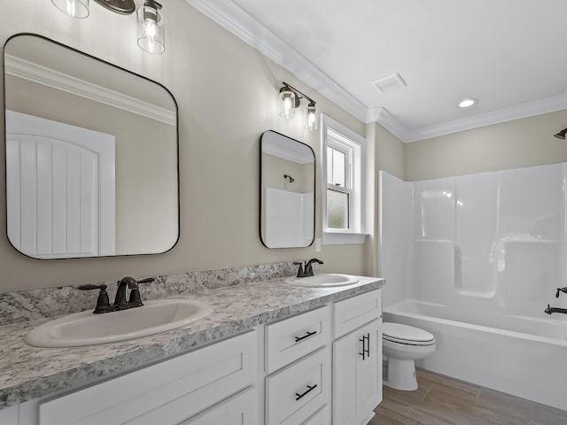 full bathroom featuring toilet, hardwood / wood-style floors, shower / bathing tub combination, ornamental molding, and vanity