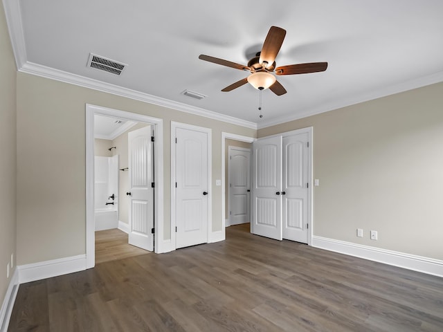 unfurnished bedroom with ceiling fan, crown molding, and dark wood-type flooring