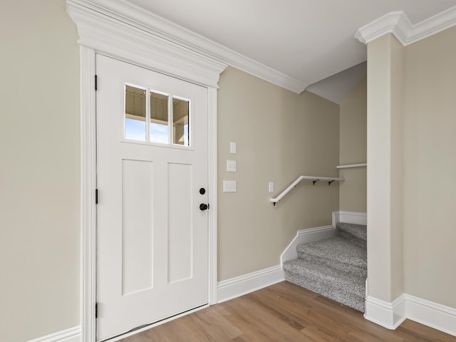 entryway with crown molding and hardwood / wood-style flooring