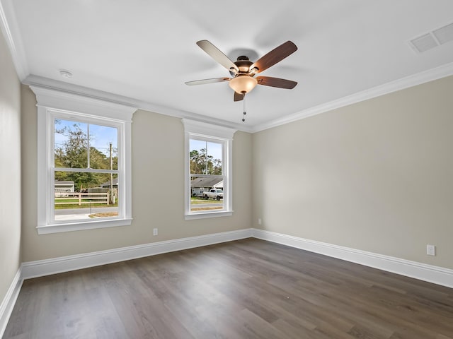 unfurnished room featuring crown molding, a healthy amount of sunlight, ceiling fan, and dark hardwood / wood-style flooring