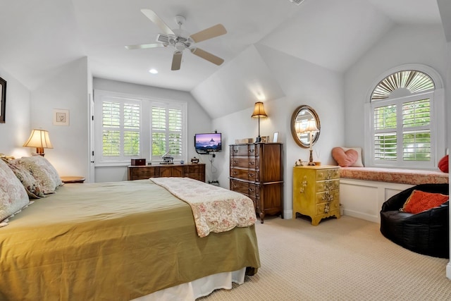 carpeted bedroom featuring lofted ceiling and ceiling fan