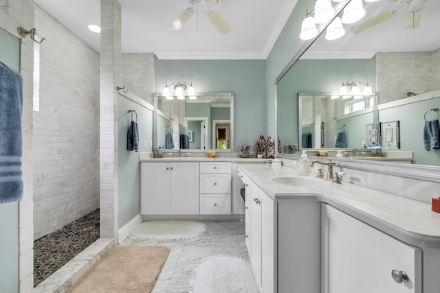 bathroom featuring ceiling fan, vanity, a tile shower, and ornamental molding