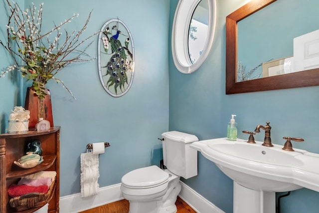 bathroom featuring hardwood / wood-style flooring, sink, and toilet