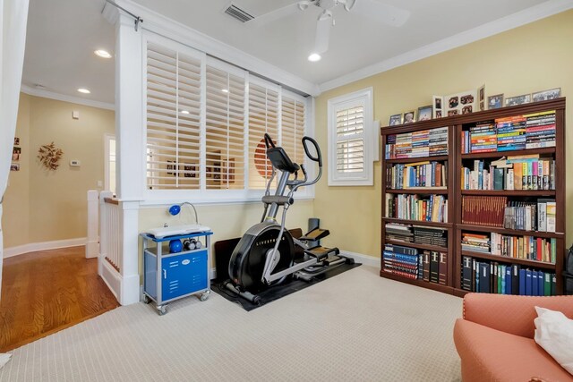 workout area featuring ornamental molding, wood-type flooring, and ceiling fan