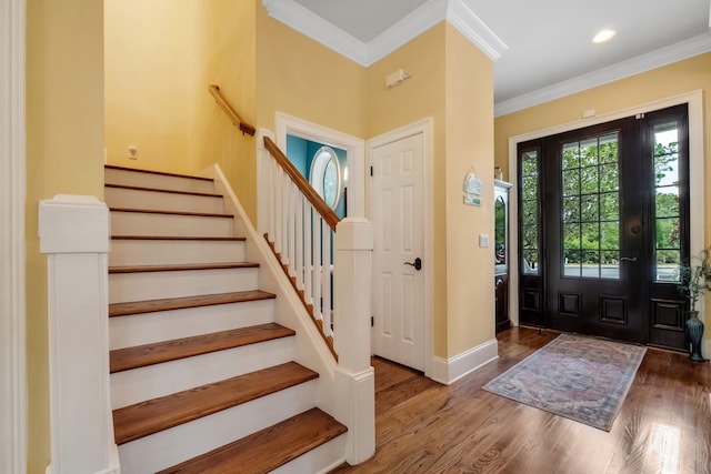 entrance foyer featuring dark hardwood / wood-style flooring and ornamental molding