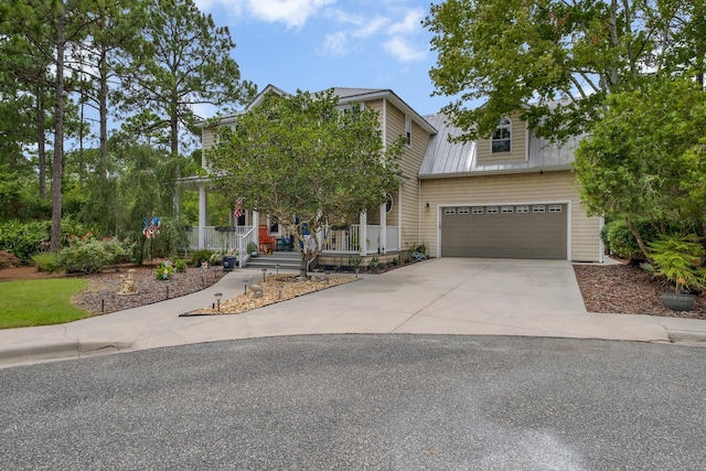 view of front of home with a garage and a porch