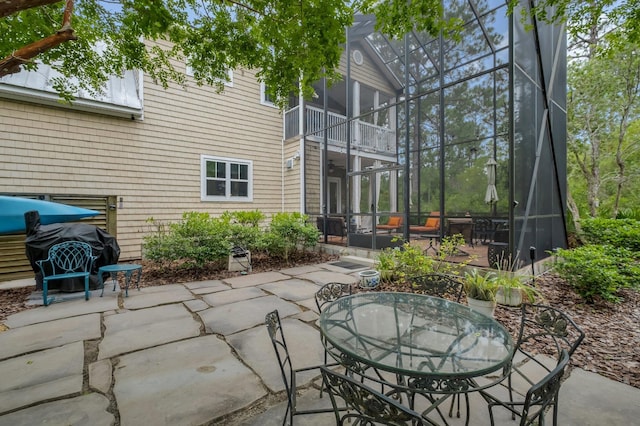 view of patio featuring a grill and a balcony