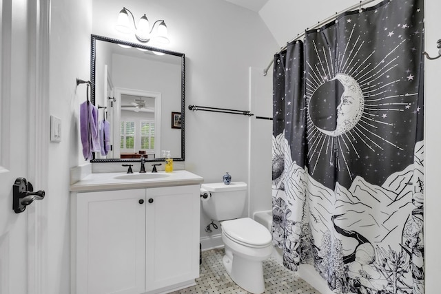 bathroom with toilet, vanity, lofted ceiling, and ceiling fan