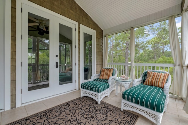 sunroom / solarium featuring vaulted ceiling