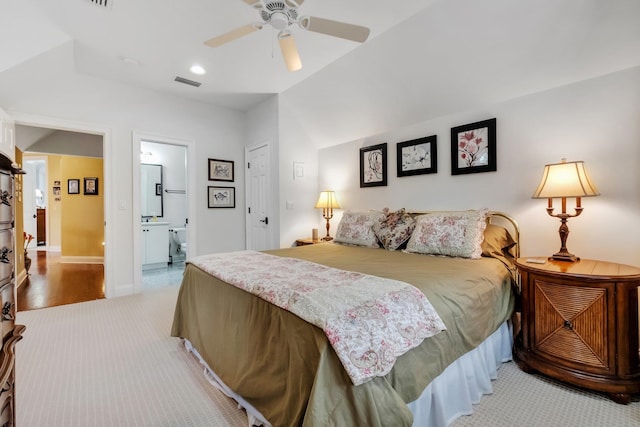 carpeted bedroom with ceiling fan, ensuite bath, and a closet