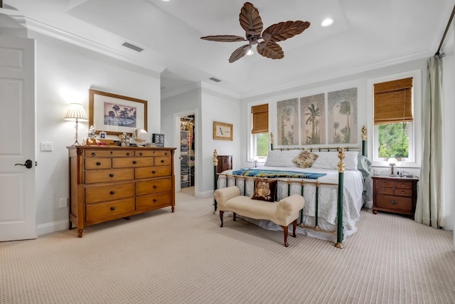 carpeted bedroom with a closet, a walk in closet, multiple windows, and ceiling fan