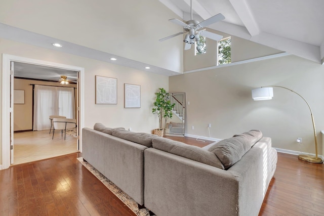 living room with hardwood / wood-style floors, ceiling fan, beam ceiling, and high vaulted ceiling