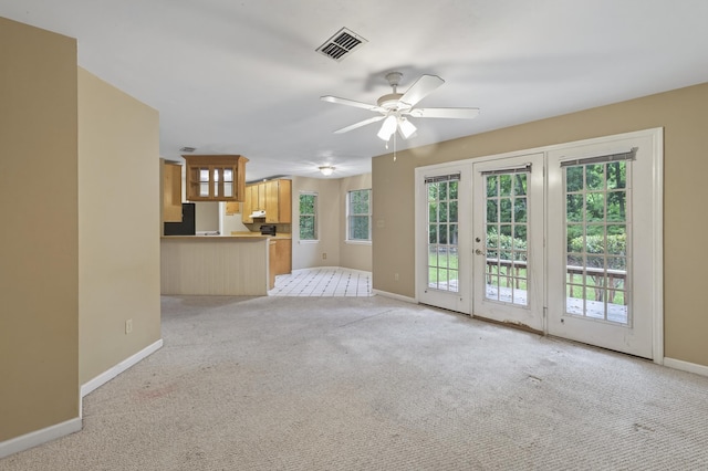 11022 Wildlife Trl, Tallahassee, FL 32312 - unfurnished living room featuring french doors, baseboards, light colored carpet, and a ceiling fan