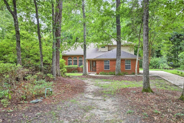 11022 Wildlife Trl, Tallahassee, FL 32312 - view of front of house featuring driveway, brick siding, and a shingled roof