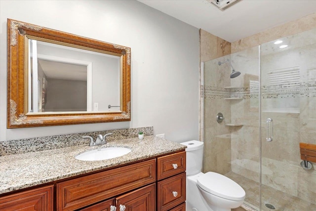 bathroom with vanity, toilet, and an enclosed shower