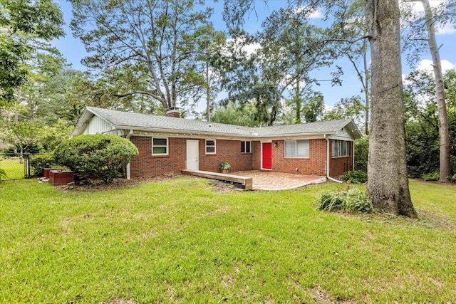 back of property featuring a lawn and a patio