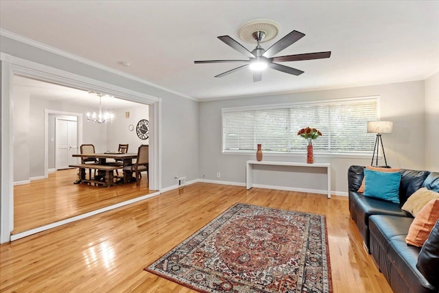 interior space featuring hardwood / wood-style floors, ceiling fan with notable chandelier, and crown molding