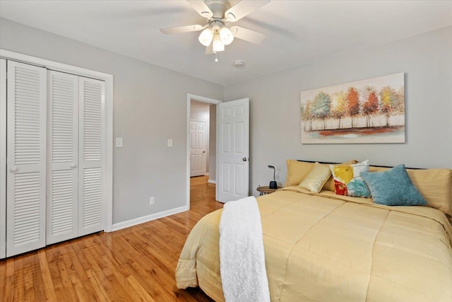 bedroom with hardwood / wood-style floors, a closet, and ceiling fan