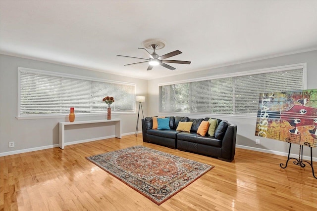 living room with ceiling fan, wood-type flooring, and ornamental molding