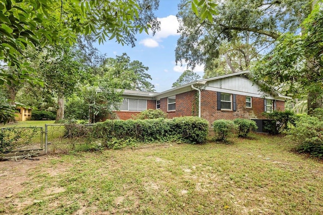 view of side of property with a yard