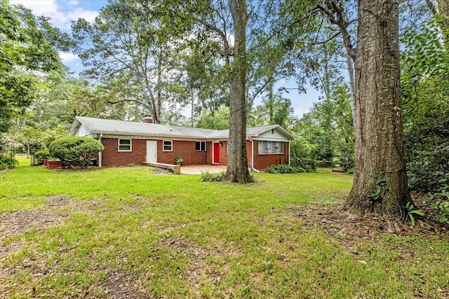 back of property featuring a patio area and a lawn