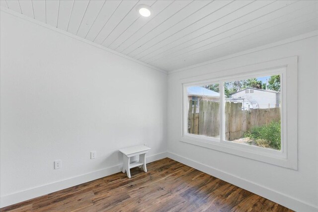 209 SE 10th St, Steinhatchee, FL 32359 - unfurnished room with crown molding, baseboards, dark wood finished floors, and wooden ceiling