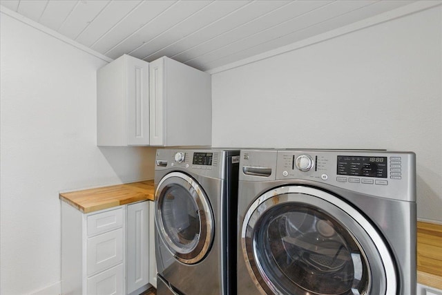 209 SE 10th St, Steinhatchee, FL 32359 - laundry room featuring washer and dryer, cabinet space, wood ceiling, wood finished floors, and crown molding