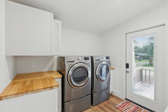 209 SE 10th St, Steinhatchee, FL 32359 - laundry room featuring independent washer and dryer, light wood-style flooring, cabinet space, and ornamental molding