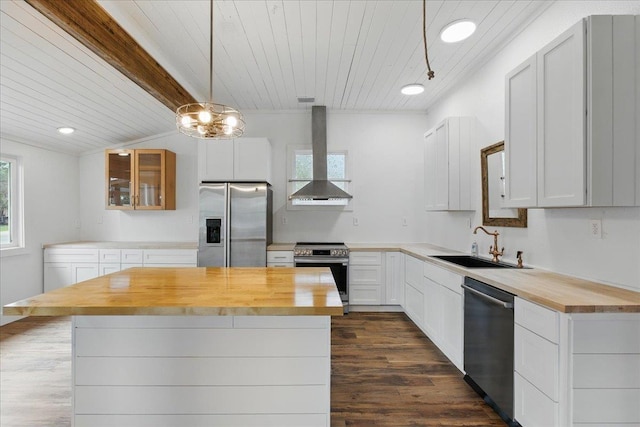 209 SE 10th St, Steinhatchee, FL 32359 - kitchen featuring stainless steel appliances, butcher block countertops, wall chimney exhaust hood, a sink, and dark wood-style floors