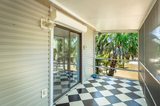 35 Sunrise Ln, Panacea, FL 32346 - unfurnished sunroom with tile patterned floors and wood walls