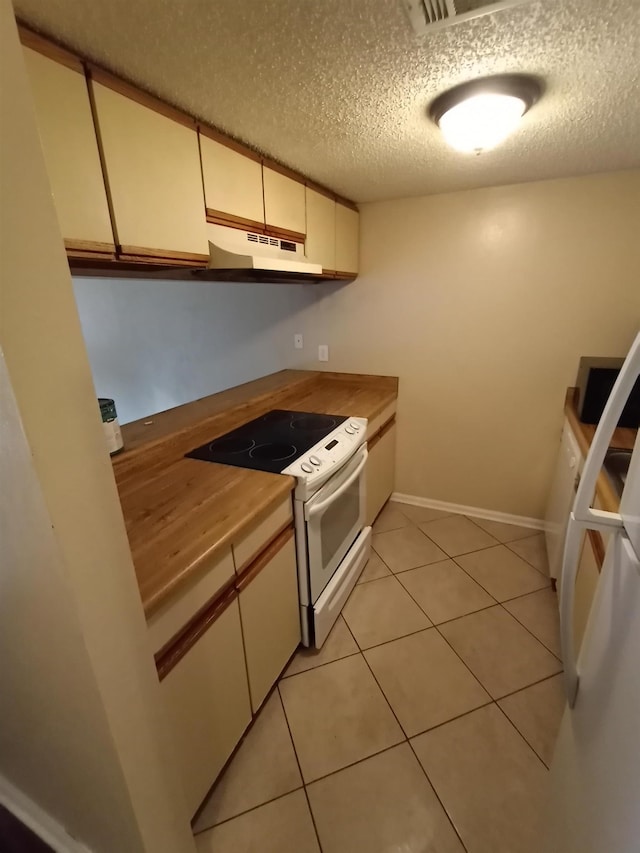 2441 Talco Hills Dr Unit C, Tallahassee, FL 32303 - kitchen with electric stove, light tile patterned floors, a textured ceiling, and cream cabinetry