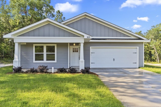 view of front of property featuring driveway, a front lawn, board and batten siding, and an attached garage