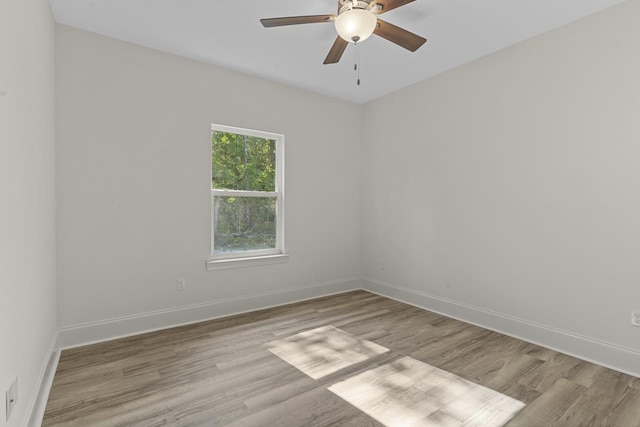 empty room with light wood-style flooring, baseboards, and ceiling fan