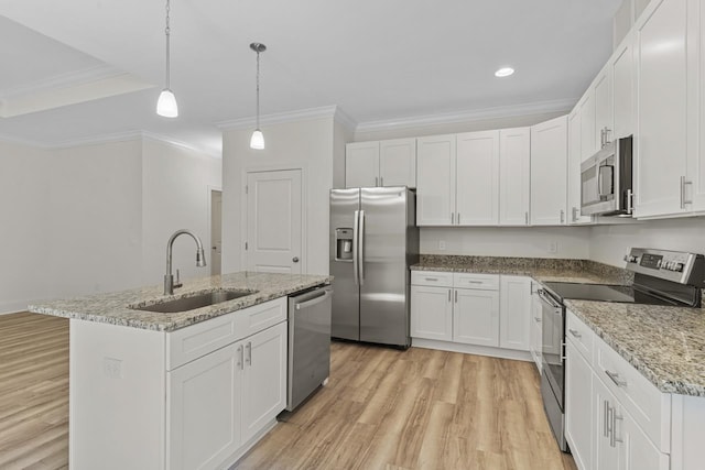 kitchen featuring appliances with stainless steel finishes, a kitchen island with sink, white cabinetry, and a sink