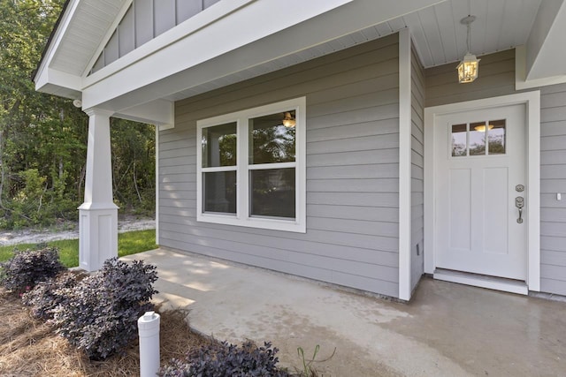 doorway to property with a balcony and board and batten siding