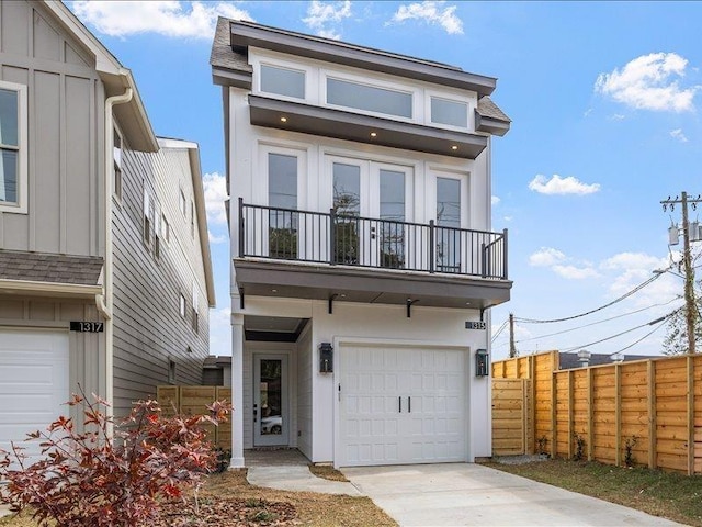 view of front facade featuring a garage and a balcony