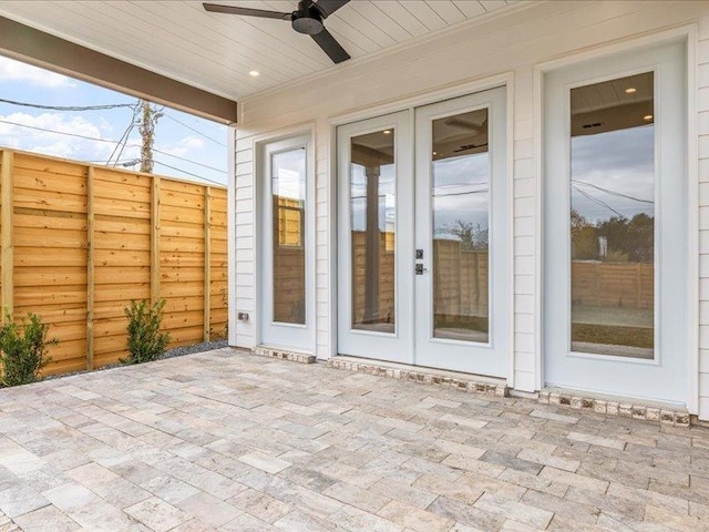 unfurnished sunroom featuring french doors and ceiling fan