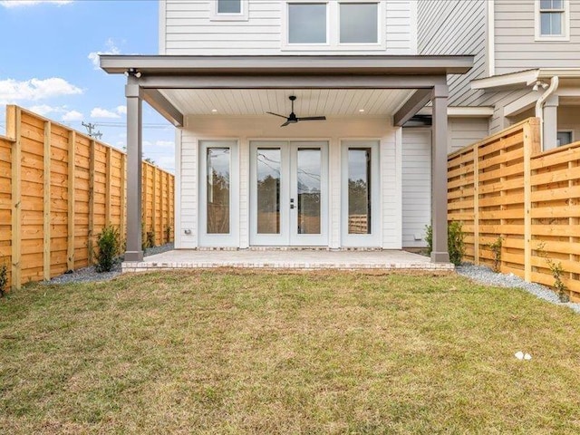 back of house with a yard and ceiling fan