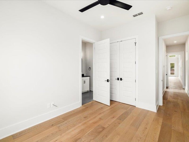 unfurnished bedroom featuring a closet, ceiling fan, and hardwood / wood-style floors