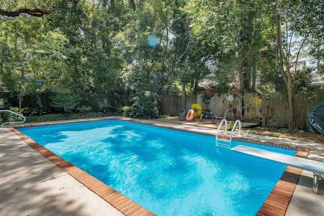 view of pool featuring a patio and a diving board