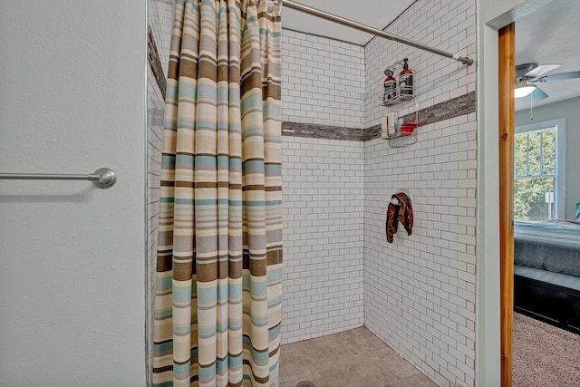 bathroom with ceiling fan and curtained shower