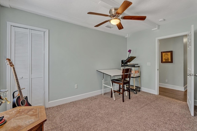 carpeted office featuring ceiling fan