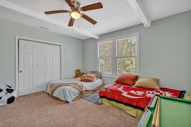 carpeted bedroom with beam ceiling and ceiling fan