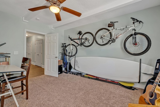 interior space with beamed ceiling and ceiling fan