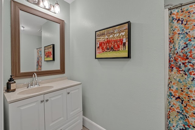 bathroom featuring vanity and a shower with shower curtain