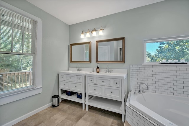 bathroom with vanity and tiled tub