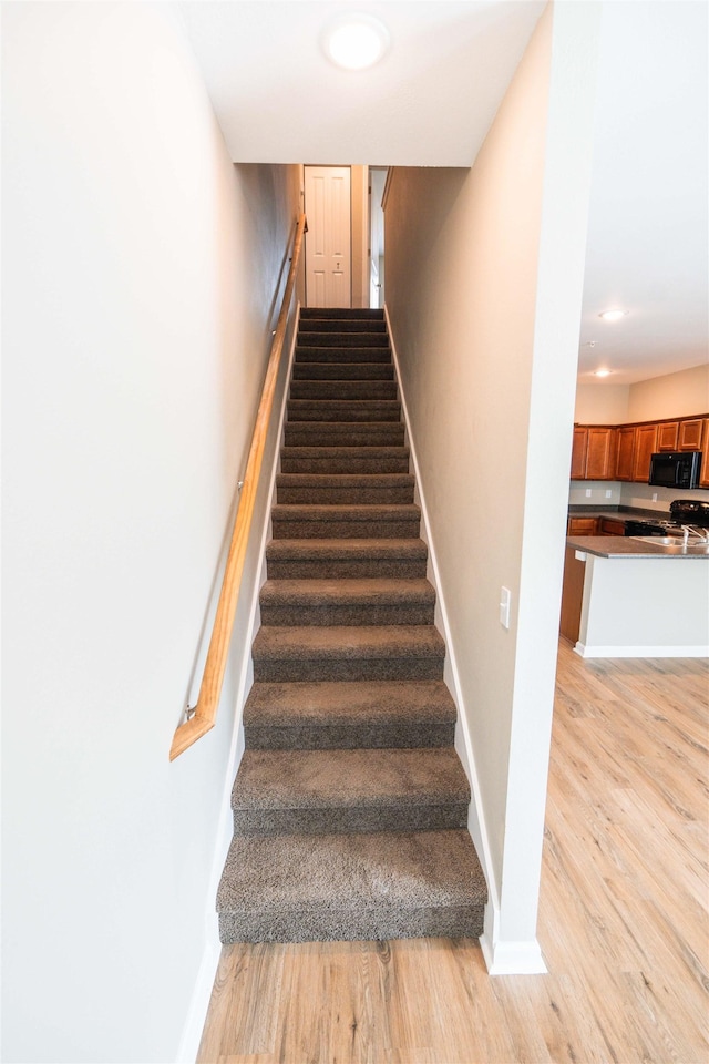 2253 Del Carmel Way, Tallahassee, FL 32303 - stairs featuring wood finished floors and baseboards