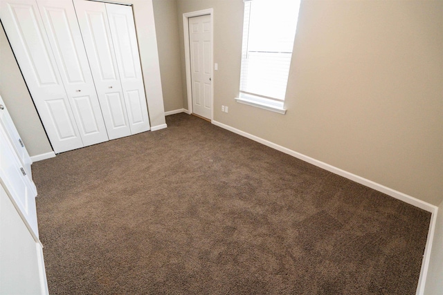 2253 Del Carmel Way, Tallahassee, FL 32303 - unfurnished bedroom with dark carpet, a closet, and baseboards