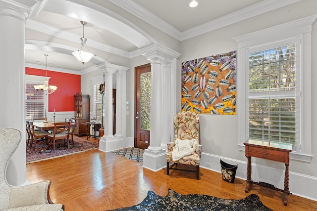 sitting room featuring ornate columns, wood-type flooring, and a wealth of natural light